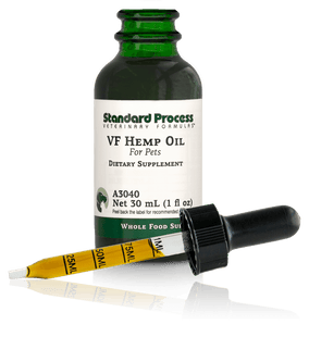 Image of a bottle of liquid VF Hemp Oil from Standard Process Veterinary Formulas next to a dropper that is included with the bottle.